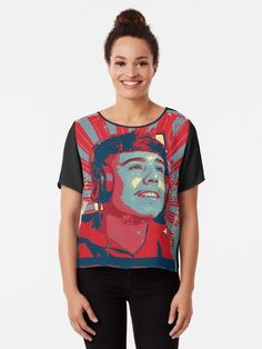 a woman wearing a red and blue t - shirt with an image of a man on it