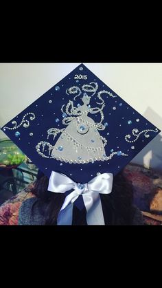 a woman wearing a graduation cap with an image of a princess on it