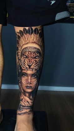 a man's leg with tattoos on it and a tiger in the middle of his leg