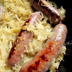 two sausages and sauerkraut in a pan