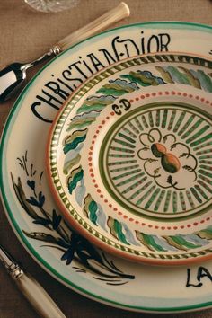 a plate with the name christiana majoror written on it next to silverware and utensils