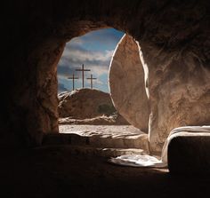 a cross is seen through an opening in a cave