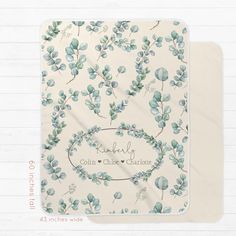 two placemats with blue leaves on them, one has a name and the other has a date