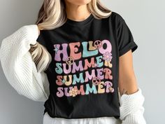 Welcome the sunny days in style with our 'Hello Summer' T-shirt! This vibrant and playful design features whimsical lettering in pastel shades, adorned with peace symbols and delicate flowers, capturing the essence of summer fun. Perfect for both daily wear and special summer outings, this graphic tee is crafted from soft, breathable fabric to keep you cool and comfortable. Whether you're hitting the beach or chilling in the park, this shirt is sure to add a touch of retro charm to your wardrobe. Product Features: Fabrication: Medium fabric (6.1 oz/yd² (206.8 g/m. Garment-dyed fabric. 100% ring-spun cotton Fit: Relaxed fit Sizing: Unisex Sizing Label: Sewn-in twill label Cute Multicolor T-shirt For Vacation, Spring Multicolor T-shirt With Text Print, Pink Funny Text T-shirt For Summer, Fun Slogan T-shirt For Spring, Spring Multicolor Slogan T-shirt, Spring Multicolor Text Print T-shirt, Multicolor Tops With Text Print For Summer, Multicolor Text Print Tops For Summer, Cute Spring Letter Print T-shirt