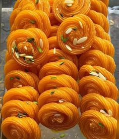 there are many oranges that have been made to look like spirals with almonds on them