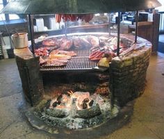 an outdoor grill with food cooking on it