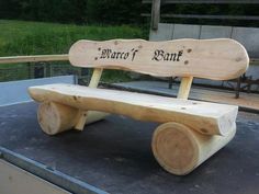 a bench made out of wood with words carved on the back and sides that read, march of bant