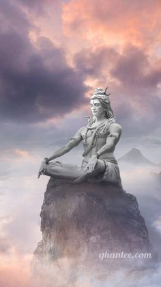 a statue sitting on top of a rock in the sky with clouds around it and mountains behind