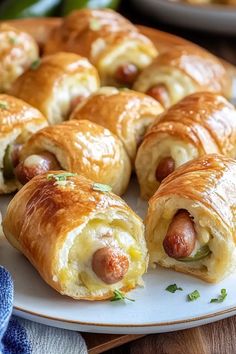 several sausage wrapped in bread on a plate