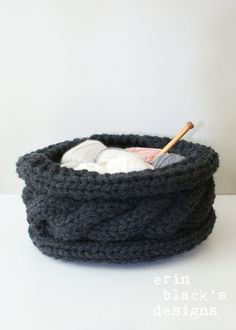 a crocheted basket is shown with a knitting needle in it and yarn on the inside