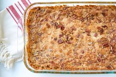 a casserole dish with pecans on top