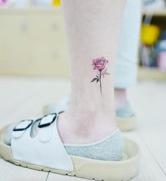 a small pink flower on the ankle is shown in an instagramture photo from instagram com