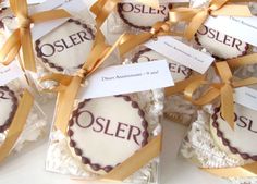 there are many cookies in the box with ribbons around them that say oslerr