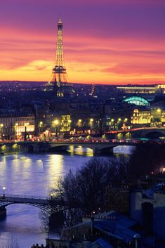 the eiffel tower is lit up at night