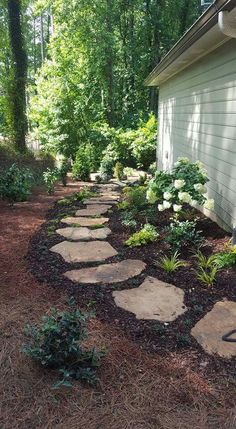 a stone path leading to a house in the woods