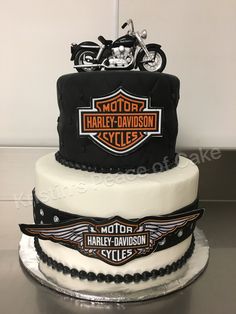 a three tiered cake with a motorcycle on it's front and back sides