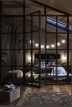 a bedroom with an open glass door leading to the bed