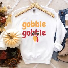 "Gobble Gobble Turkey Thanksgiving Crewneck Sweater Shirt, Cute Pumpkin Thanksgiving Hoodie, Hello Fall, Happy Thanksgiving Gift ☼ P L E A S E   R E A D   B E F O R E   P L A C I N G   O R D E R☼ Please note that these sweatshirts are unisex size meaning they are not women's fit sweatshirts. With unisex sizing, these are great for both men and women. For men, order true to size. For women, order true to size or size down by 1 for a more fitted look. For an oversized look, order one to two sizes up. If you are unsure about the size you should order, please refer to the size chart in the pictures.    Unisex Sizing - Available in Plus Sizes! Due to the nature of the fabric as well as your monitor or mobile screen colors may differ slightly. Our tops and tees are handcrafted one at a time. It Sweatshirt Svg, Spooky Vibes Svg, Thankful Sweatshirt, Thanksgiving Sweater, Thanksgiving Sweatshirt, Funny Thanksgiving Shirts, Thankful Shirt, Turkey Shirts, Gobble Gobble