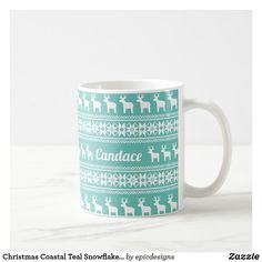 a coffee mug with reindeers and snowflakes on it