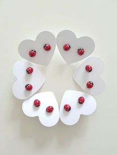 four hearts with ladybugs on them are arranged in a circle