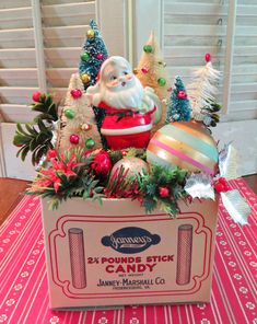 a box filled with christmas decorations on top of a table