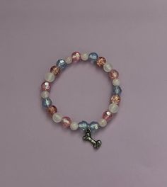 a beaded bracelet with a cross charm