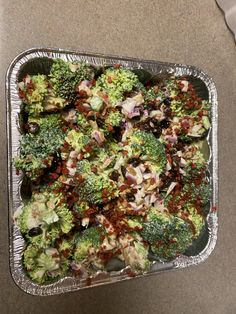 broccoli florets and other vegetables in a foil container