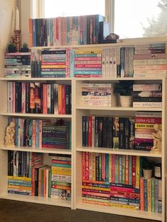 a white book shelf filled with lots of books