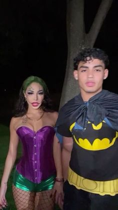 a man and woman dressed up as batman and batgirl