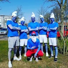 a group of men in blue shirts and white hats posing for a photo with their arms crossed