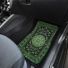 the interior of a car with a green and black floor mat on top of it