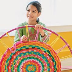 a young boy is playing with a colorful toy