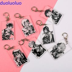 six keychains with anime characters on them, one is black and the other is white