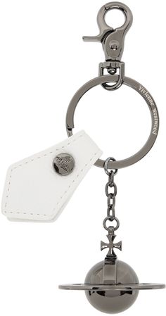 a metal key chain with a white tag hanging from it's end and a silver ball on the other side