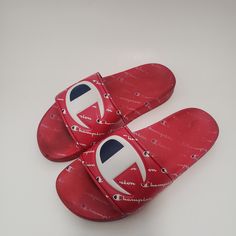 Elevate Your Kid's Casual Look With These Vibrant Red Champion Ipo Repeat Slide Sandals. These Unisex Sandals Are Perfect For Travel, Activewear, And Casual Occasions. They Are Made Of A Comfortable Synthetic Upper Material With A Blended Fabric Lining. The Sandals Feature A Low-Top Shoe Shaft, Standard Shoe Width, And Minimal Cushioning Level. The Rubber Cleat Type And Slip-On Style Make It Easy To Wear And Take Off. These Sandals Are Perfect For Summer, Fall, And Spring Seasons. Buy Them Now A Red Round Toe Sandals With Rubber Sole, Comfortable Red Sandals With Round Toe, Red Flat Sandals With Rubber Sole, Casual Red Closed Toe Sandals, Red Trendy Sandals With Cushioned Footbed, Trendy Red Sandals With Cushioned Footbed, Trendy Red Open Toe Flip Flops, Red Trendy Open Toe Flip Flops, Comfortable Non-slip Red Sandals