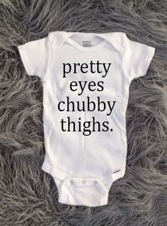 a baby bodysuit with the words my dad rocks on it sitting on a furry surface