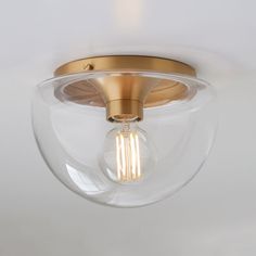 a light that is on the ceiling with a glass ball around it's base