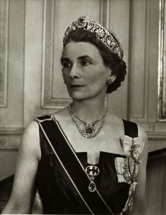 an old black and white photo of a woman wearing a tiara