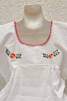 White blouse with multicolored details handmade by Mexican artisans. . It is important to mention that absolutely all the process is done by hand, so the size, shape and color can varybetween pieces. . Measurements:↕ 30 1/53 in↔ 16 1/2) in(armhole: 19 2/3) Handmade White Cotton Tops, Handmade White Folk Style Top, Handmade White Folk Top, White Bohemian Blouse With Machine Embroidery, Traditional White Handmade Blouse, Traditional Handmade White Blouse, Multicolor Cotton Blouse With Machine Embroidery, White Cotton Embroidered Top, Handmade White Folk Blouse