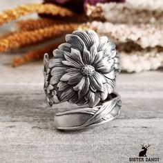 Detailed Marigolds bloom on this Art Nouveau-style ring. These fascinating flowers symbolize the precious nature of life and abundance.  A beautiful pattern made in the early 1900s. This would make a striking statement piece or the perfect gift for the garden or nature lover in your family! This ring is made from a vintage sterling silver spoon, 925, nickel-free. This ring will be adjusted to the size you request but it can easily be tightened or loosened at home should you want a different fit. Antique Flower Jewelry For Anniversary, Bohemian Flower Rings For Anniversary, Unique Flower-shaped Anniversary Ring, Nature-inspired Silver Flower Ring, Heirloom Flower-shaped Engraved Jewelry, Heirloom Flower Engraved Jewelry, Unique Engraved Flower Jewelry, Heirloom Silver Flower Ring, Heirloom Silver Flower Jewelry