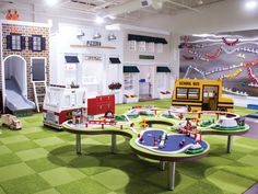 children's play area with toys and furniture in indoor setting, including train set