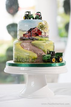 a cake decorated with farm scene and tractor on the top is sitting on a pedestal