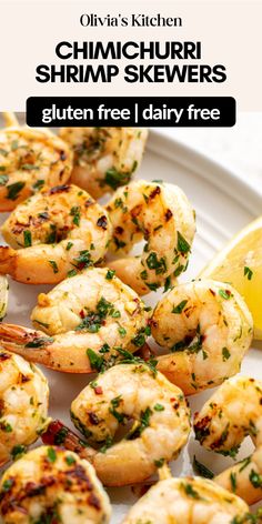 grilled shrimp skewers on a plate with lemon wedges