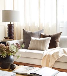 a living room filled with furniture and pillows