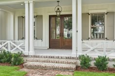 the front door of a house with steps leading up to it