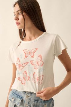 Garment washed graphic t-shirt. Vintage-style graphic print with butterfly and flower graphics. Round neckline. Short sleeves. Lettuce-edge cuffs and hem. Cropped length. Relaxed fit. 100% Cotton. Imported top designed and printed in LA. Model wears size S. White Vintage Print T-shirt For Spring, Cute Butterfly Print T-shirt For Spring, White Tops With Vintage Print For Spring, White Top With Vintage Print For Spring, White Cotton Top With Butterfly Print, Butterfly Print Short Sleeve Tops For Spring, White Butterfly Print Graphic Tee, Short Sleeve Tops With Butterfly Print For Spring, Spring Graphic Tee With Butterfly Print