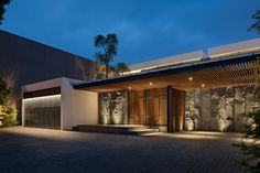 a modern house is lit up at night