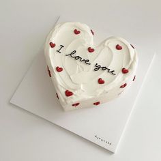 a heart shaped cake with i love you written on it