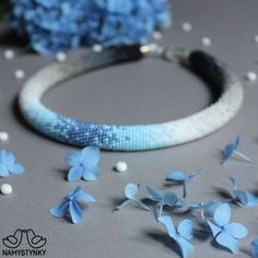 This blue gradient necklace is made of high-quality Czech beads. It is an original creation based on floral motifs and patterns. The necklace is highly versatile, suitable both for everyday wear and formal occasions. Features: Color: blue, white, black, gray. Length (approximate): 47 cm (18.5 in) This necklace in purple color https://www.etsy.com/listing/579867840/orchid-gradient-necklace-crochet-beaded?ref=shop_home_active_1 This necklace in pink color https://www.etsy.com/listing/580045462/pin Minimalist Blue Beaded Choker Necklaces, Minimalist Handmade Blue Beaded Necklaces, Minimalist Blue Beaded Choker Necklace, Handmade Blue Minimalist Necklace, Handmade Minimalist Blue Necklace, Beaded Necklace Blue, Crochet Beaded Necklace, Beaded Hat Bands, Necklace Minimalist Jewelry