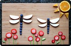 a wooden board topped with lots of different types of flowers